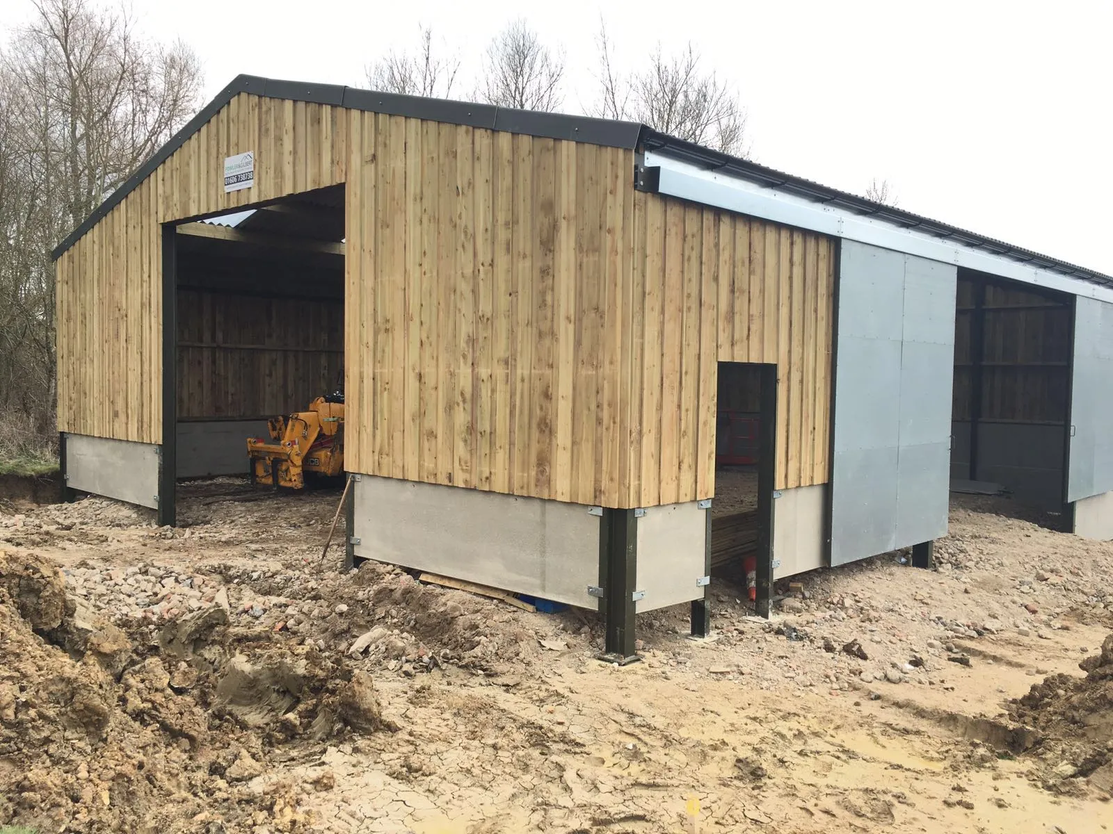 Building clad in vertical timber Yorkshire boarding above a concrete panel plinth